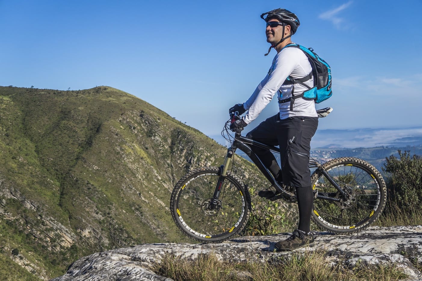 A person riding a bike on a rocky hill Description automatically generated with low confidence